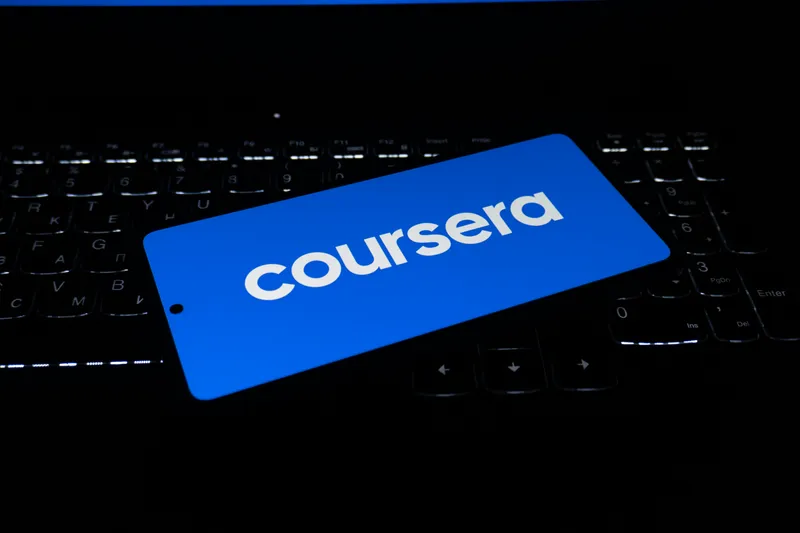Person studying with a laptop and books