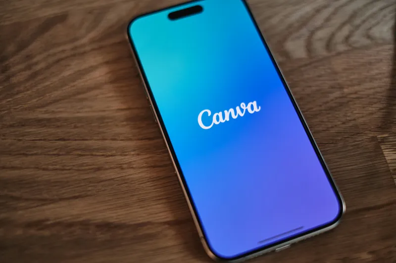 Person designing on a laptop using Canva AI