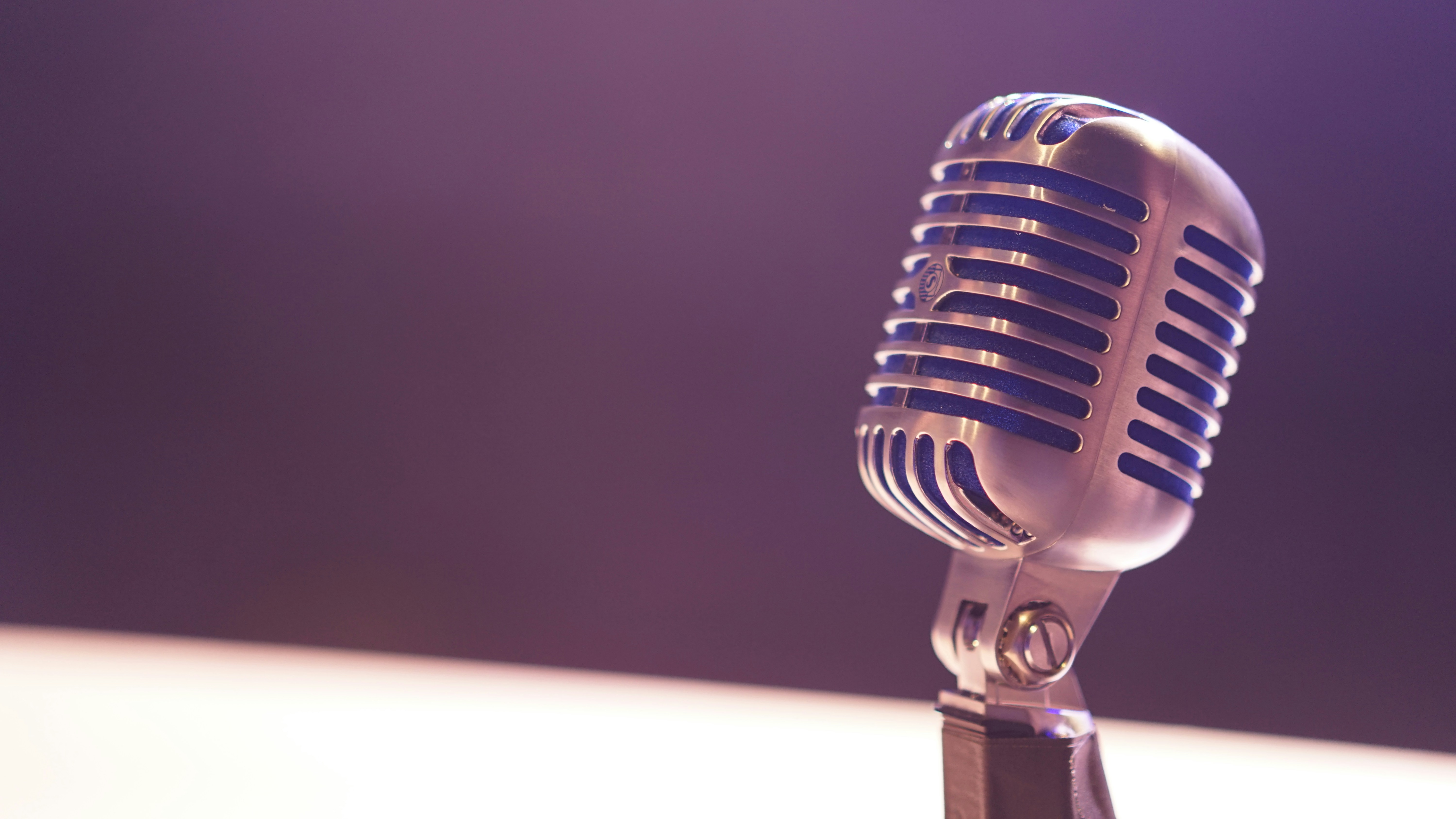 Person recording voice in a home studio with a professional microphone