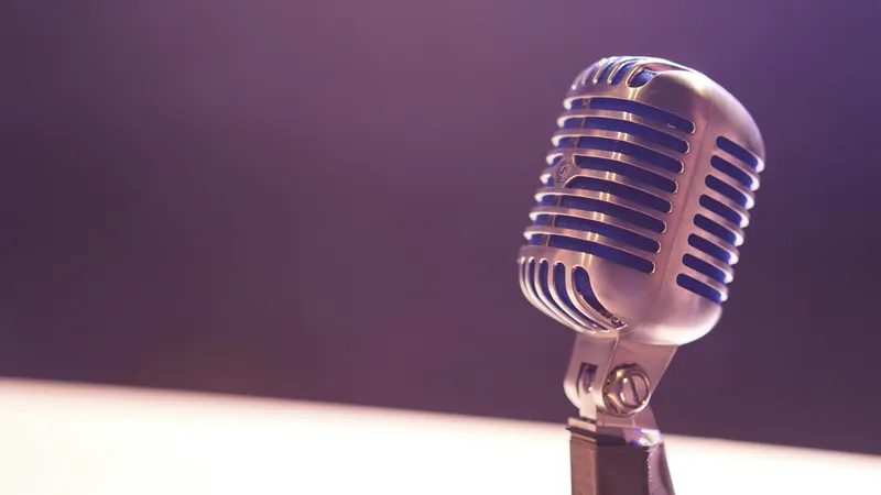 Person recording voice in a home studio with a professional microphone