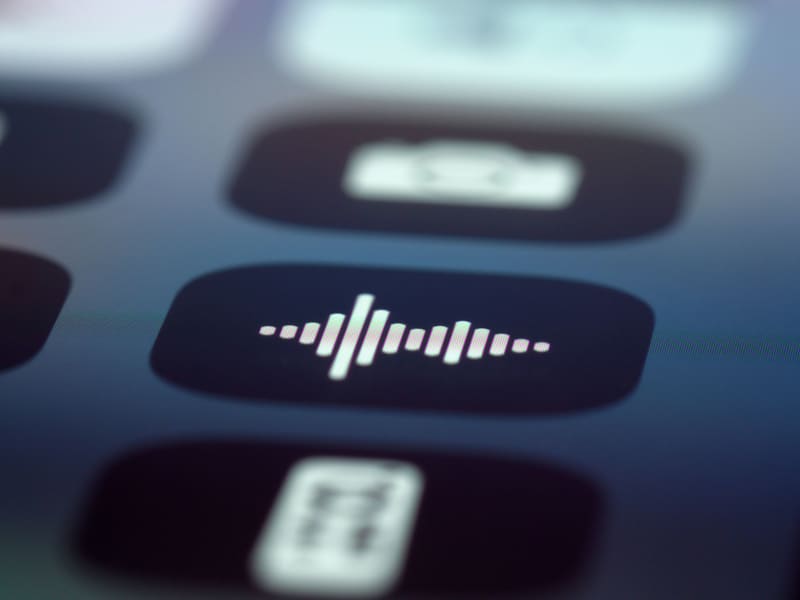 Person using voice mode on a smartphone while AI responds